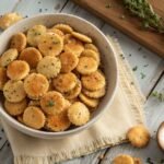 Ranch Oyster Crackers in a bowl, seasoned with ranch and herbs, on a wooden table.